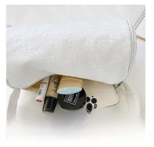 Top view detail of large capacity interior for white floral embossed cylinder bag