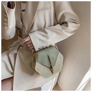 Detail of woven PU patchwork bag with olive green leather flap and gold tassel chain