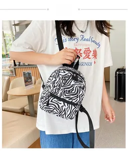 Close-up of zebra pattern canvas backpack with adjustable black nylon straps on a model