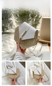 Detail of woven straw and white PU leather hexagonal crossbody bag with gold chain strap