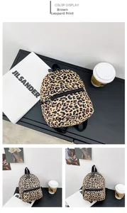 Detail showing brown leopard print canvas backpack with black straps and side pockets