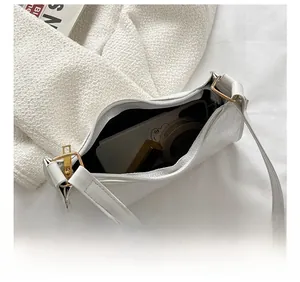 Top view showing the internal storage of the white croc-embossed leather underarm bag