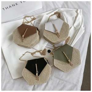 Detailed top view of hexagonal woven straw crossbody bags with leather flap and gold chain