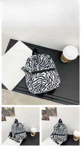 Detail view of the zebra pattern canvas backpack with adjustable straps and front pocket