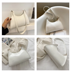 Detail shots of a white crocodile embossed baguette bag with gold metal buckle