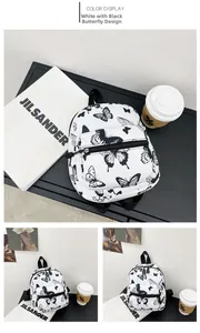 Detail view of the black butterfly print on white canvas backpack with zip closure