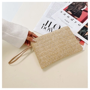 Close-up of handmade wheat grass woven clutch with stylish chevron pattern and wrist strap
