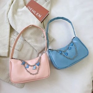 Pink and blue baguette underarm bags with butterfly chain and silver hardware details