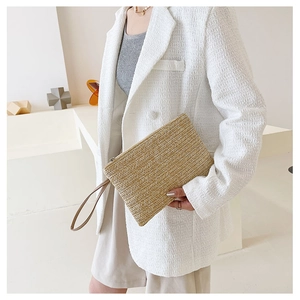 Detail showing V-pattern straw weave and khaki handle on vintage clutch bag