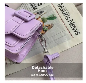Detail of lavender PU leather bag featuring a silver metal detachable hook and fine strap