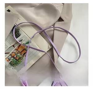 Detail showing lavender mini bag with resin chain and neat stitching on smooth faux leather