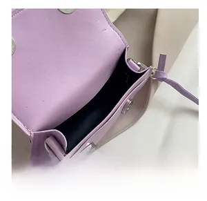 Detail shot of mini lavender square bag showing interior space and magnetic closure