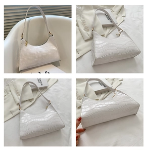 Detailed views of a white crocodile embossed baguette bag with golden hardware details