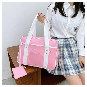Close-up of the heart-shaped clear window and detachable pouch on this pink JK uniform bag