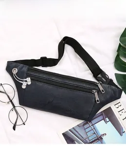 Detail view of navy blue PU leather belt bag with headphone port and multiple zip pockets