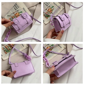 Detail view of mini lavender crossbody bag featuring thick plastic chain and flap closure