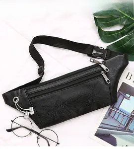 Detail of black PU leather waist bag featuring three zipper pockets and an earphone port