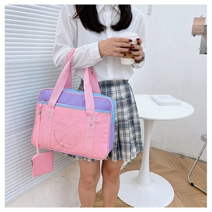 Detail of JK style travel tote bag with heart-shaped window and small pink pouch