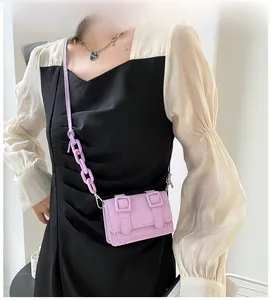 Chic lavender purple mini crossbody bag with chain strap shown on model for size reference