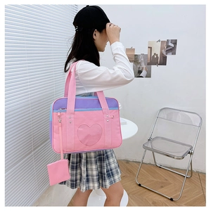Detail of pink and purple ita bag with heart window and mini coin purse attachment