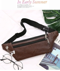 Detail of dark brown pebble leather waist bag with silver zipper accents and adjustable strap