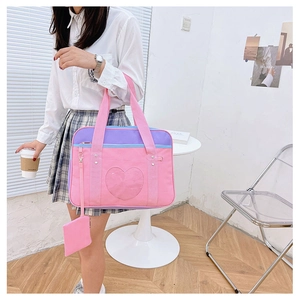 Close-up of heart-shaped clear window and small pouch on canvas JK uniform travel bag