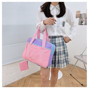 Detail of the heart-shaped clear window on a pastel canvas Itabag with a small side pouch