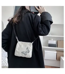 Close-up of portable reflective butterfly crossbody bag with durable metal hooks