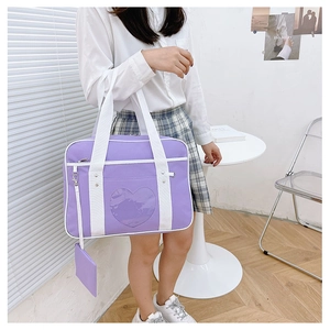 Close-up of light purple JK uniform bag with a heart-shaped transparent window and mini pouch