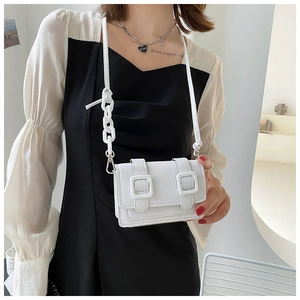 Mini white PU leather crossbody bag with double buckle and chain strap on female model