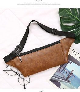 Detailed shot of brown leather waist bag with adjustable strap and plastic buckle on white background