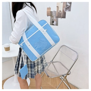 Blue ita bag with heart window and white strap shown in a JK uniform lifestyle setting