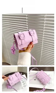 Detail view of mini purple PU leather square bag with decorative buckles and chain