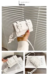 Detail of white mini crossbody bag with matte finish and stylish plastic chain strap