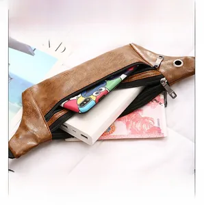 Internal view of brown PU leather waist bag showing spacious zipper compartments