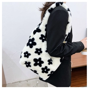 Detail of soft plush floral tote bag showing textured white faux fur with black flower pattern