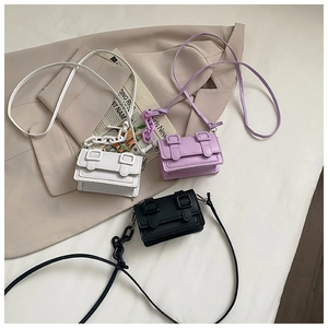 Detailed view of mini crossbody bags in white, purple and black with chunky chain straps