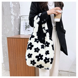 Detail of plush floral tote bag shown on shoulder, highlighting soft faux fur texture