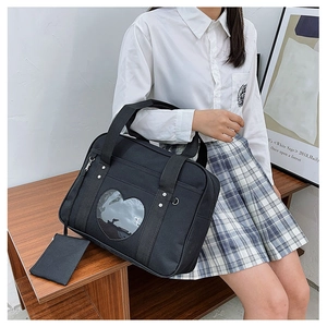 Detail view of black canvas ita bag featuring heart-shaped clear window for JK uniform