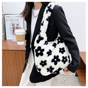 Detailed close-up of a plush tote bag with a black and white floral pattern and soft texture