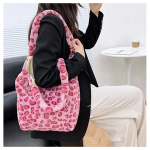 Pink leopard print plush tote bag with soft faux fur texture shown on model's shoulder