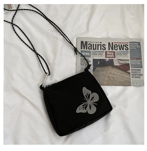 Detail of black oxford fabric mini crossbody bag with reflective butterfly print