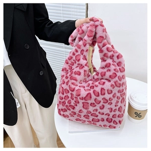 Detail of pink leopard print plush handbag showing soft faux fur texture and trendy pattern