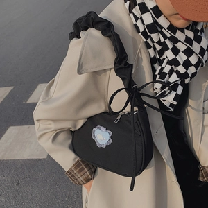 Black canvas crossbody bag with blue heart whale patch and cloud ribbon shoulder strap