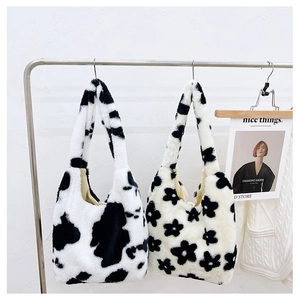 Detail of plush faux fur shoulder bags in black and white cow and floral prints
