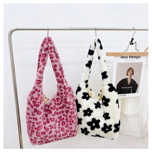 Close-up of plush tote bags in pink leopard and floral prints for fall and winter