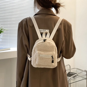 Plush lamb wool mini backpack with bunny ears for women, shown on model's back