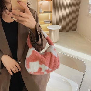 Pink and white cow print plush hobo tote bag for women shown in a lifestyle mirror selfie