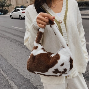 Faux fur cow print tote bag with white zipper closure for casual autumn and winter fashion