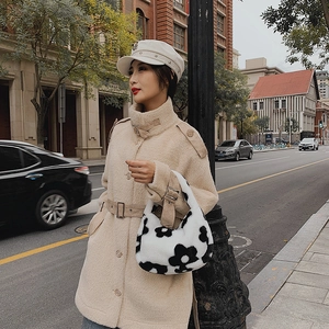 Chic beige plush coat with floral faux fur tote bag and nautical cap in urban setting
